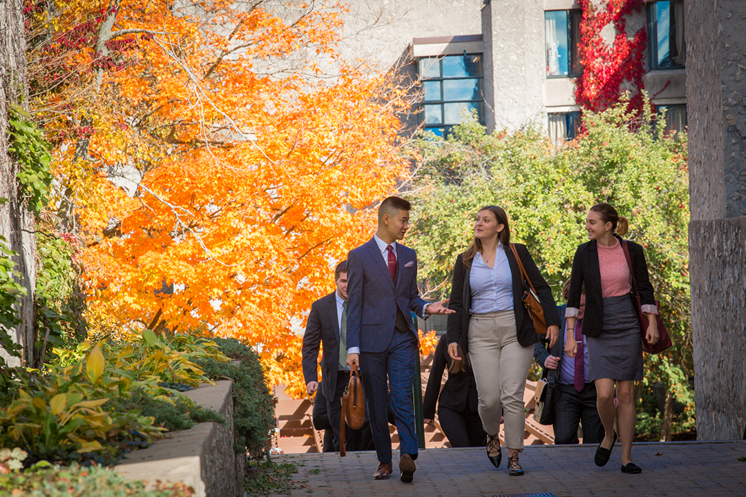 Accounting students walking through Trent University campus in the fall