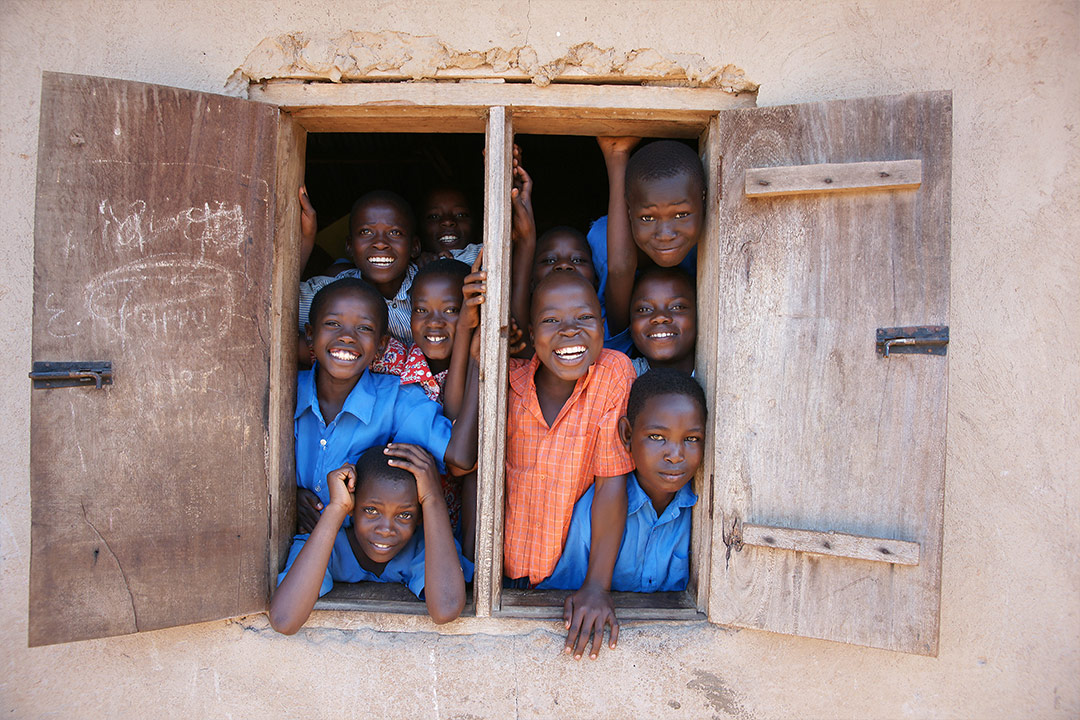 African children look out from window