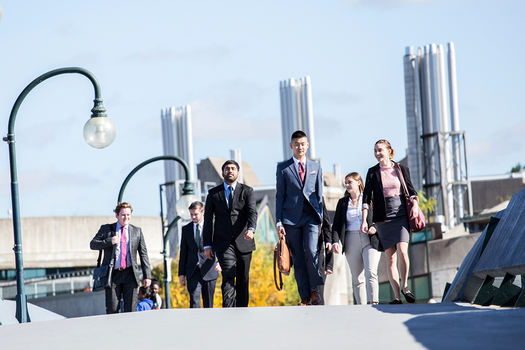 Business Administration students walking across Faryon Bridge
