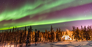 Aurora Borealis over Teepees in Yellowknife in the witner time