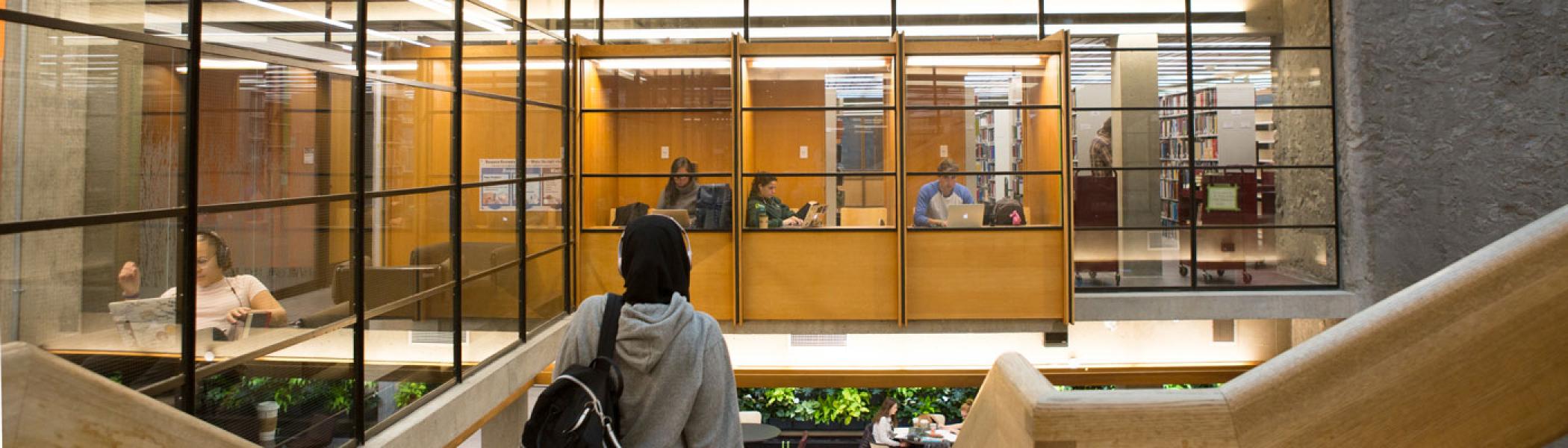 View from the top of the stairs at Bata library showing students working in study carols