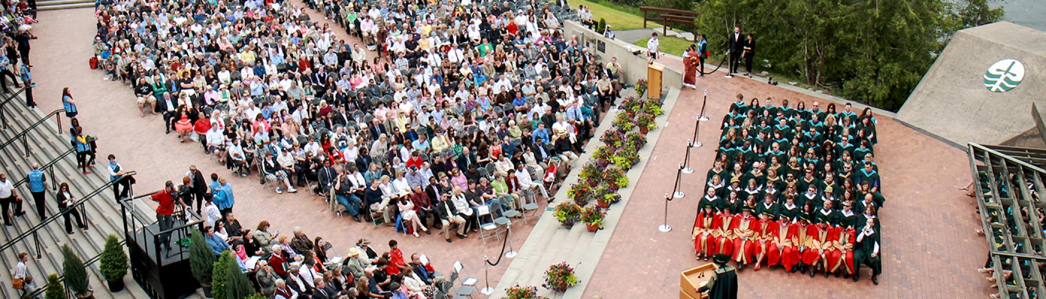 Arial photo of the podium at Bata library during convocation. The seats are all full.