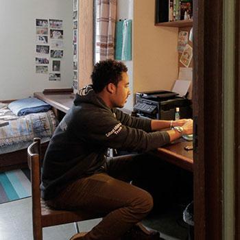 Student studying in Trent University dorm room