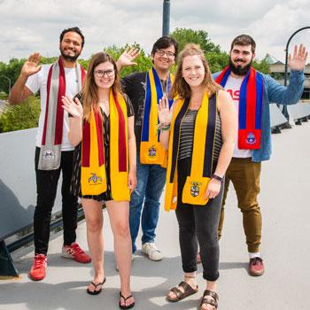 Student representatives from the colleges gathered for a photo wearing their scarves.
