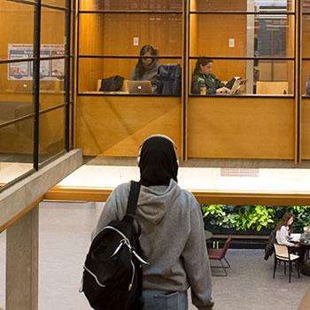 Student walking down stairs in newly renovated Bata Library