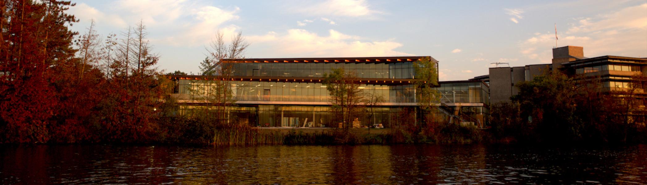 An exterior view of the student center with the river in the foreground