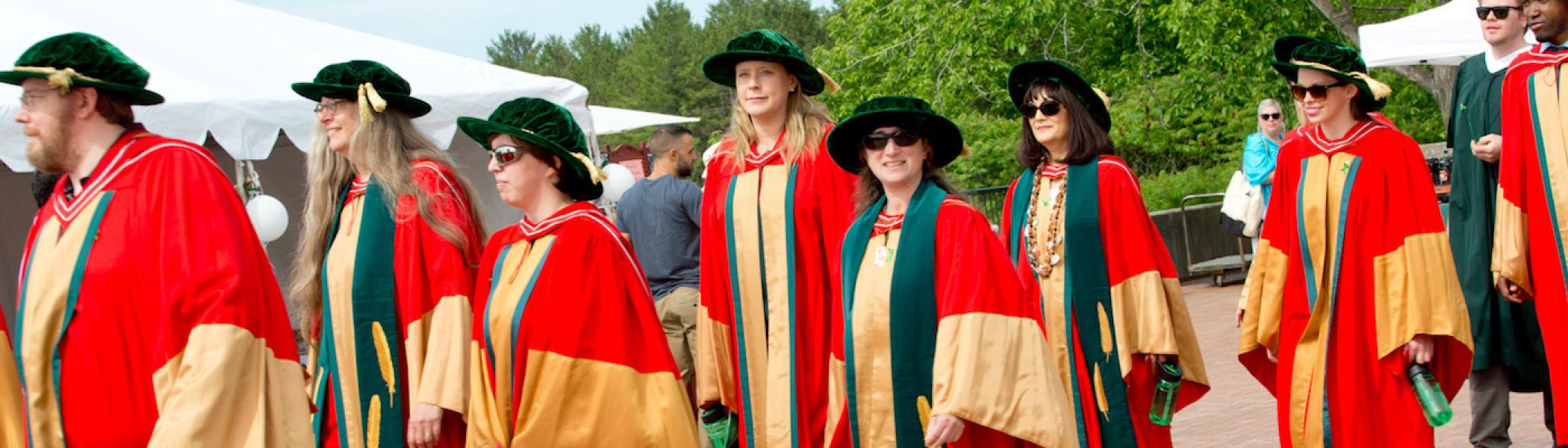 A group of graduate students walking in a line on convocation