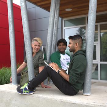 3 students sitting outside at Trent Durham